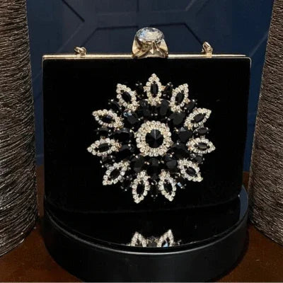 Black velvet evening clutch with crystal floral brooch and large gemstone clasp