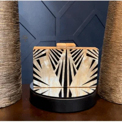 Art deco wooden card holder with black and gold geometric pattern on modern desk